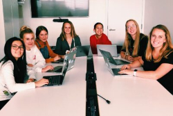 Group of digital research interns sitting at a table